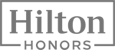 The image shows the logo for Hilton Honors, a popular hotel loyalty program. The text is in a rectangular frame.